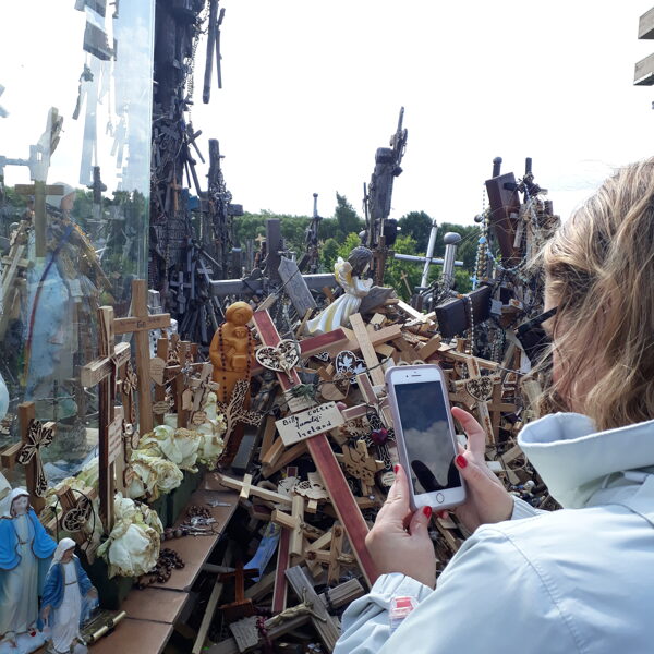 Taking pictures of crosses left by visitors at the Hill of Crosses