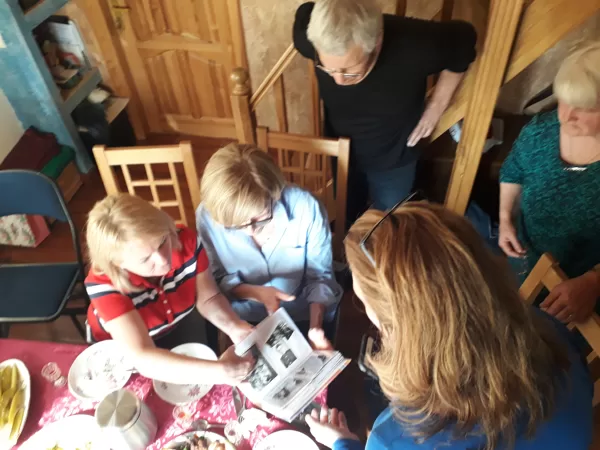 Looking at old family photos with newly found relatives