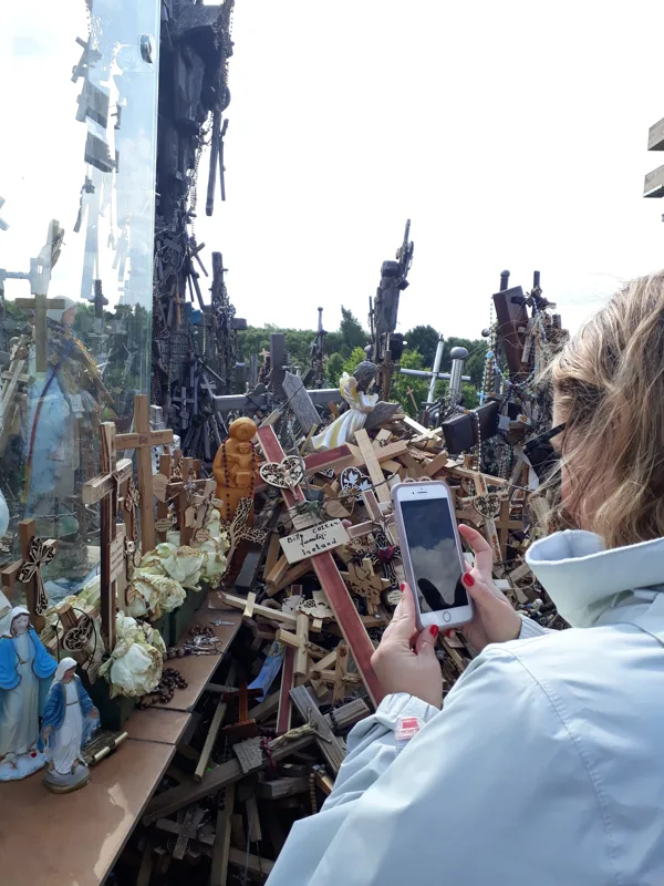 Taking pictures of crosses left by visitors at the Hill of Crosses